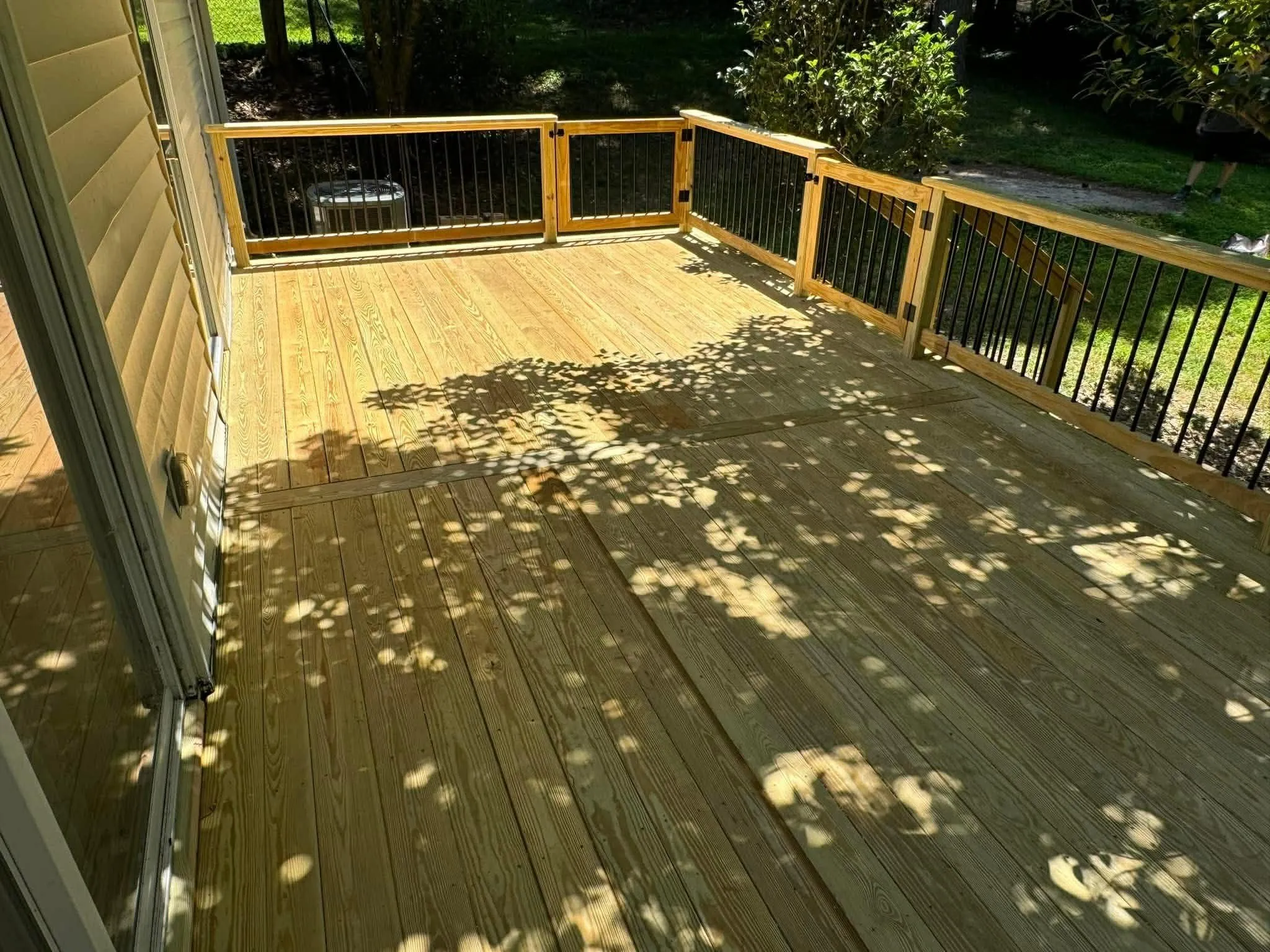 Wood deck surface in a leafy yard