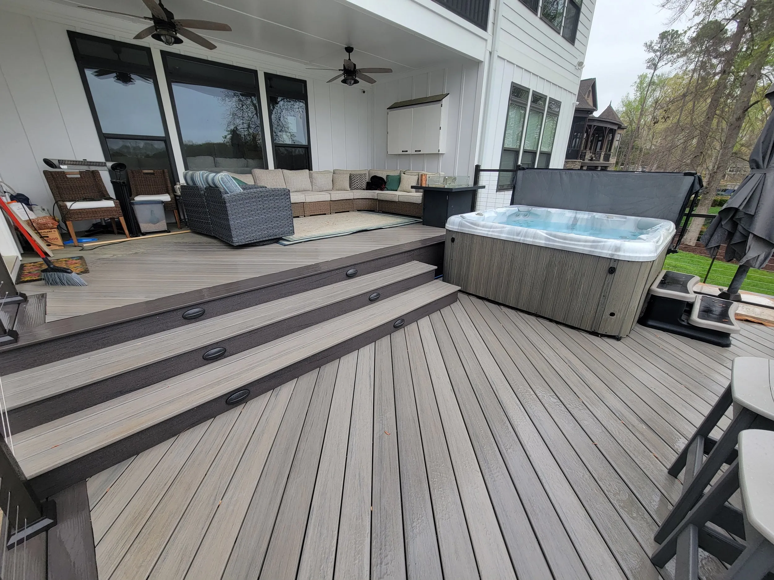 Deck and hot tub beside a covered porch