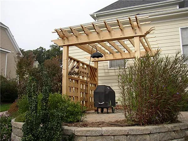 Timber pergola and privacy wall beside a home