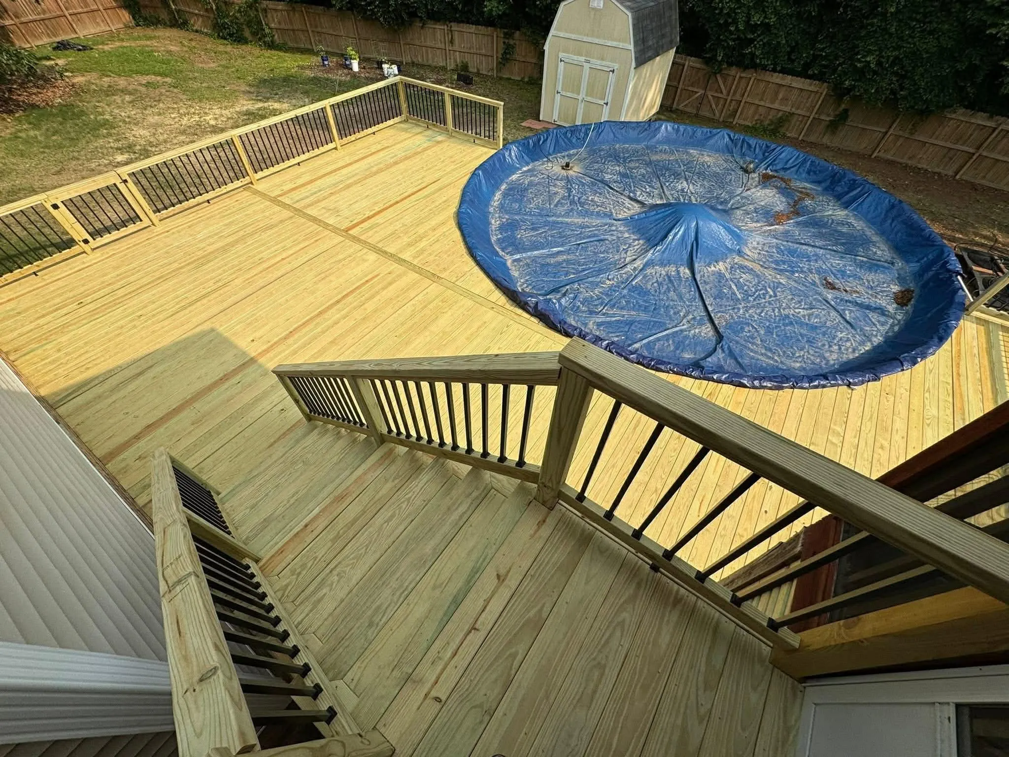 Wood deck surrounding an above-ground pool