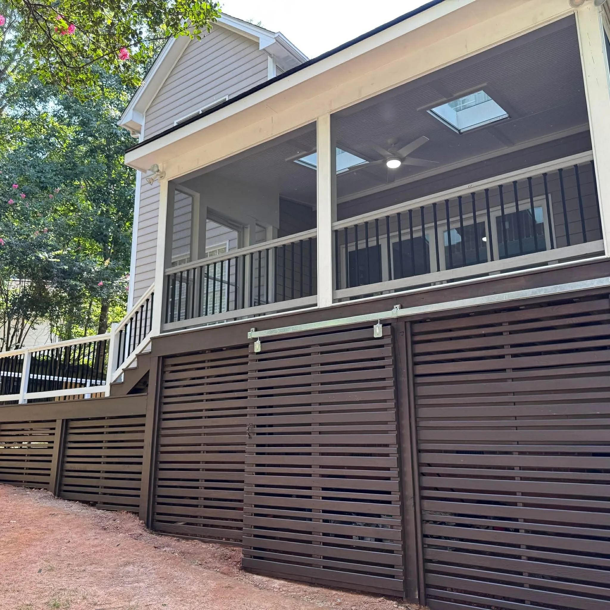 Screened porch with a solid roof and framed mesh panels