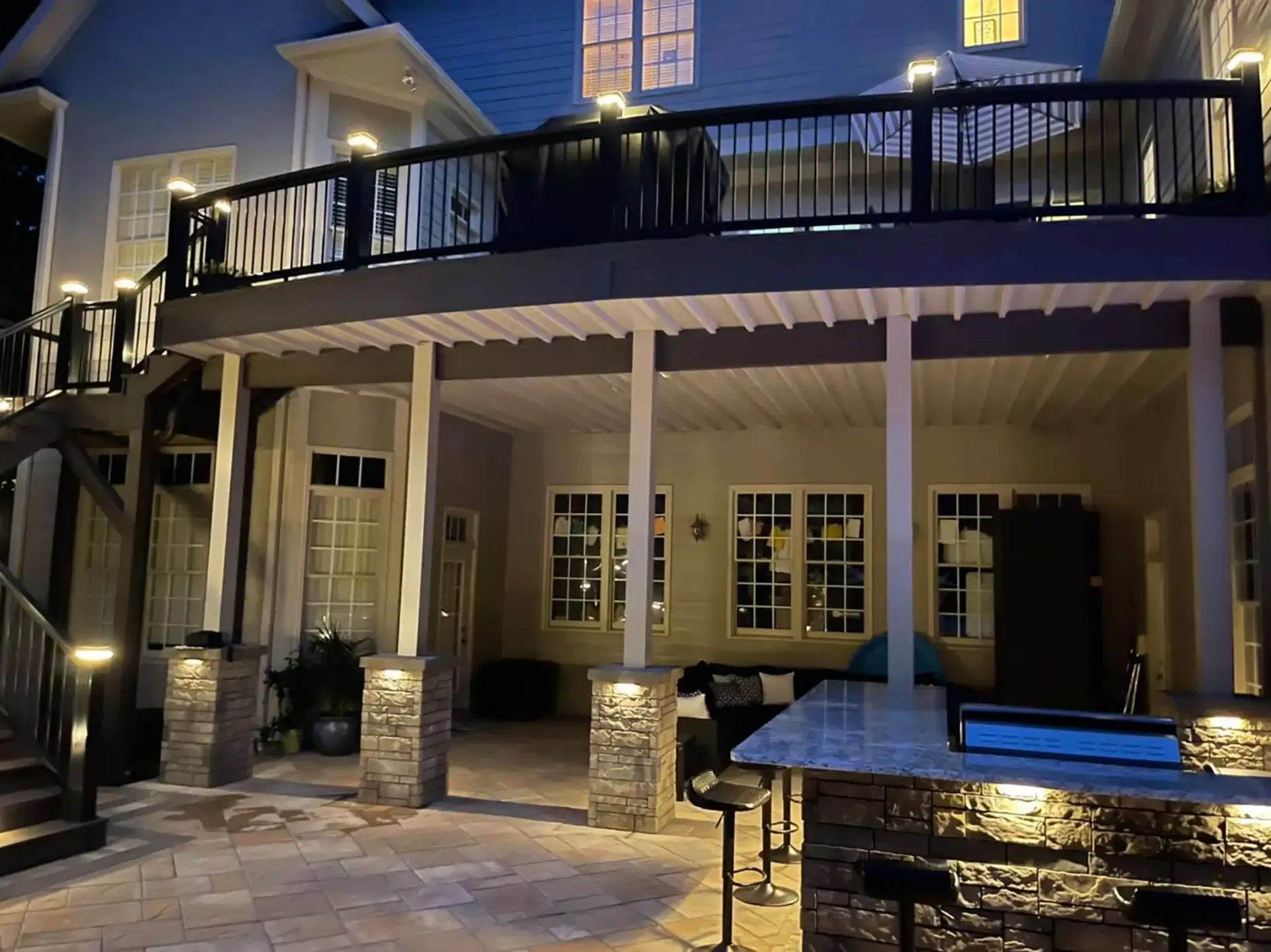 Elevated deck above a sheltered patio with a finished underside