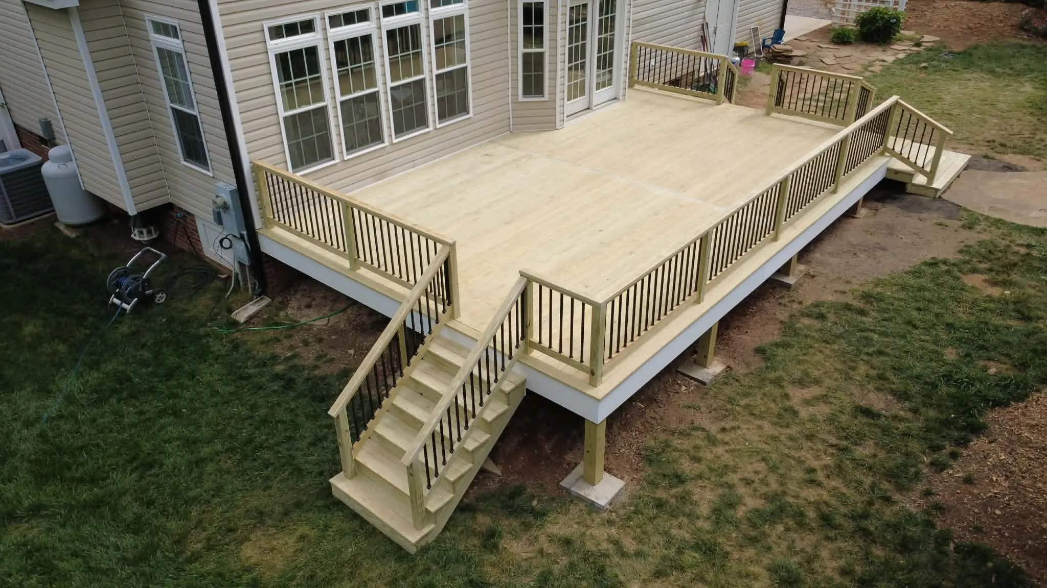 Natural wood deck with broad corner stairs